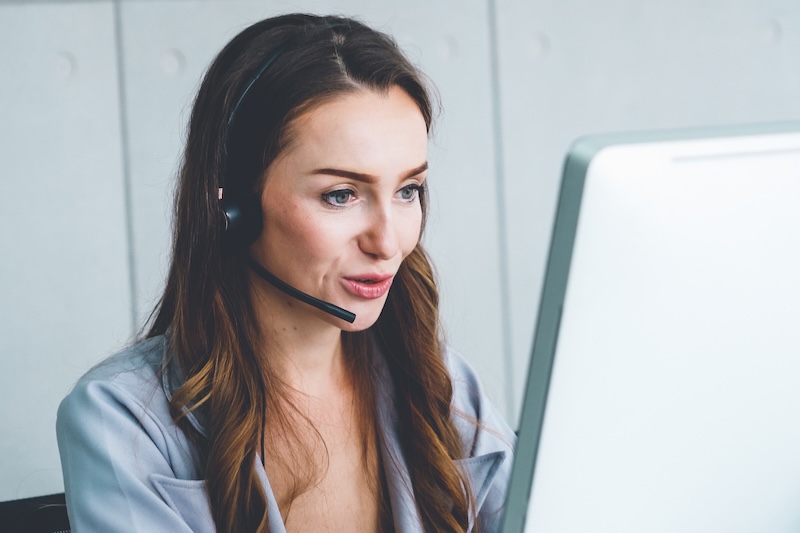 Business people wearing headset working in office Business people wearing headset working in office to support remote customer or colleague. Call center, telemarketing, customer support agent provide service on telephone video conference call.