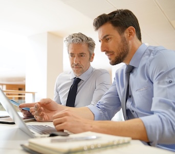 Male coworkers discussing business strategies